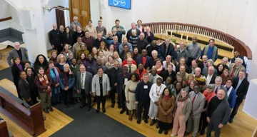 All the United Methodist leaders meeting in Denmark stand for a group photo after worship at Jerusalem United Methodist Church in downtown Copenhagen. Photo by Heather Hahn, UM News.